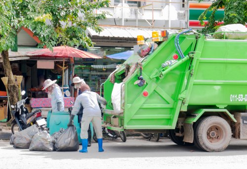 Workers loading materials into a builders skip